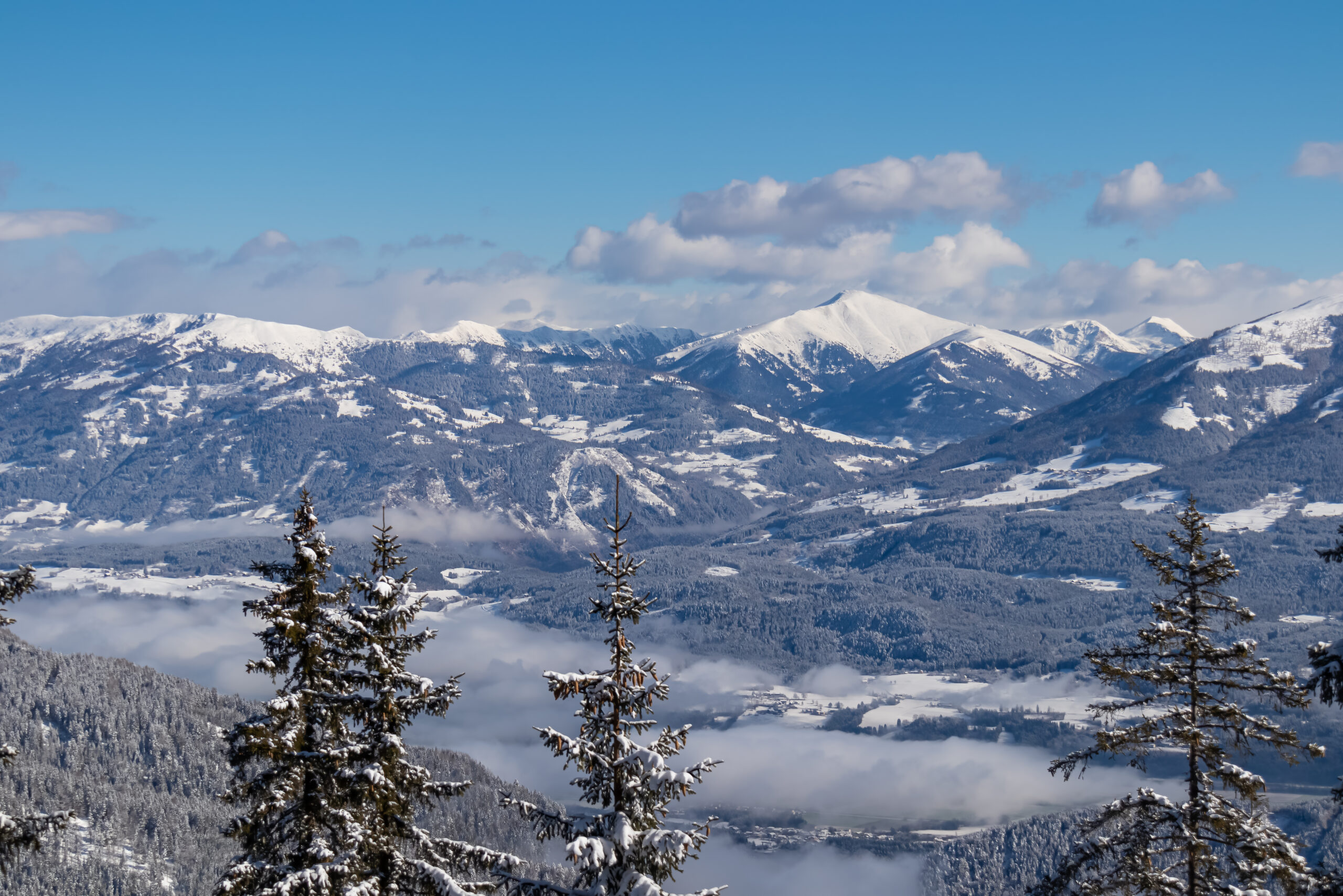 Panoramic view of the snowcapped mountain ranges of the Nock Mountains (Nockberge) seen from Kobesnock near Bad Bleiberg, Carinthia, Austria, Europe. Rosennock in winter wonderland alpine landscape